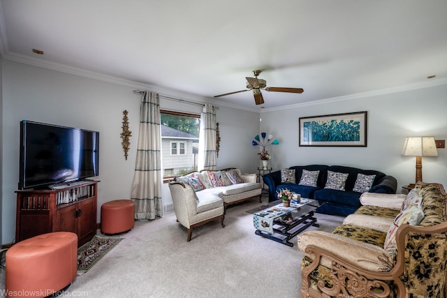 living room featuring ornamental molding, ceiling fan, and carpet flooring