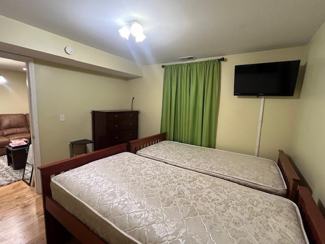 bedroom with hardwood / wood-style floors