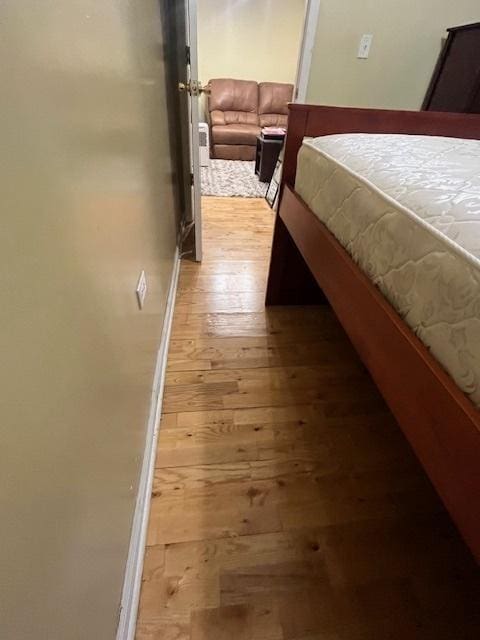 bedroom with hardwood / wood-style flooring