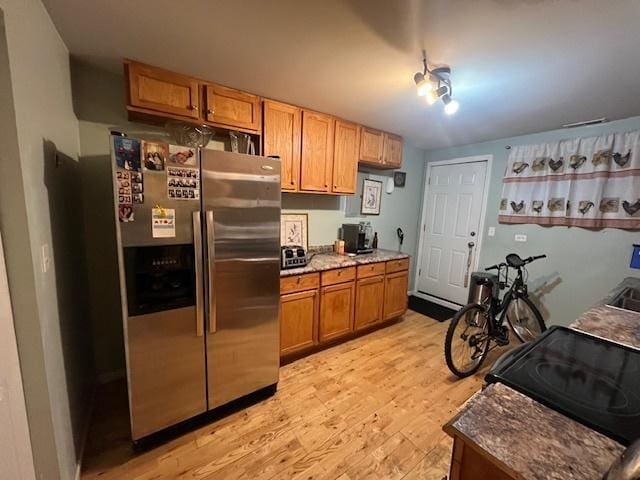 kitchen featuring stainless steel fridge and light wood-type flooring