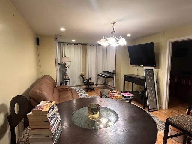 dining area featuring light hardwood / wood-style floors and a notable chandelier