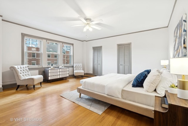 bedroom with crown molding, wood-type flooring, and ceiling fan