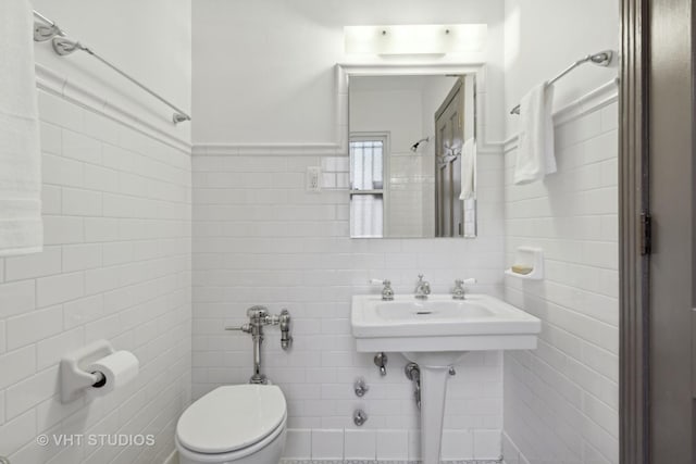 bathroom featuring tile walls and toilet