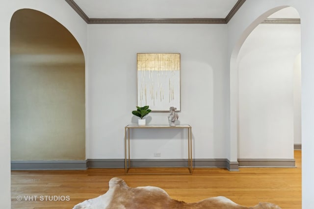 interior space featuring crown molding and hardwood / wood-style flooring