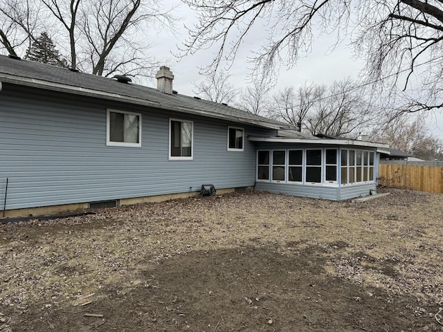 rear view of house featuring a sunroom