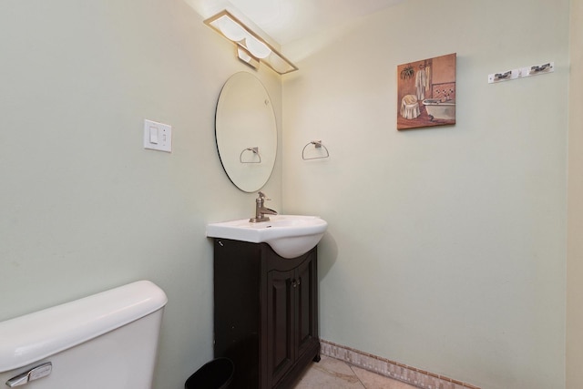 bathroom with vanity, toilet, and tile patterned flooring