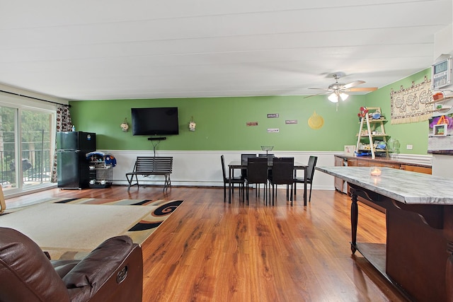 living room with hardwood / wood-style flooring and ceiling fan