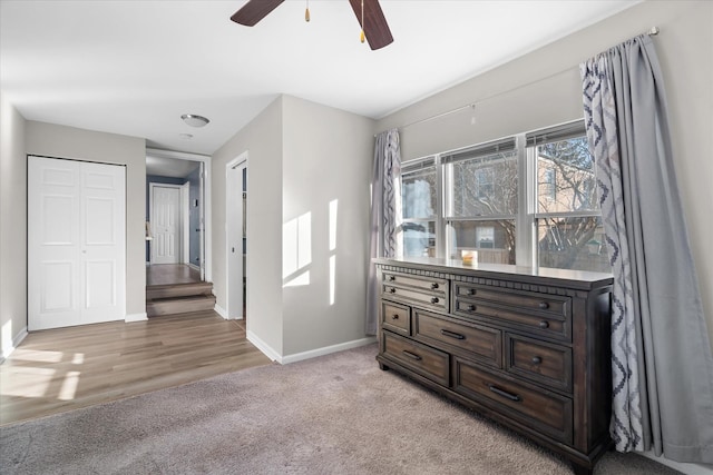 bedroom featuring light colored carpet and ceiling fan