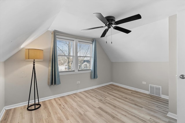 additional living space with lofted ceiling, light hardwood / wood-style floors, and ceiling fan