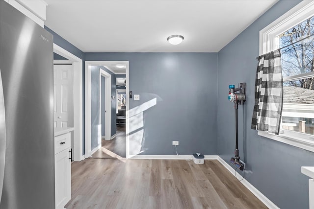 clothes washing area featuring light wood-type flooring