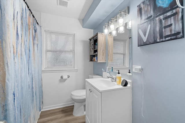 bathroom with vanity, hardwood / wood-style flooring, and toilet