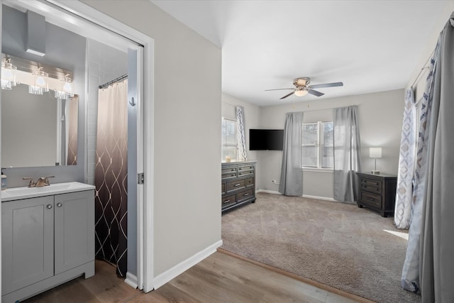 bathroom featuring ceiling fan, vanity, and wood-type flooring