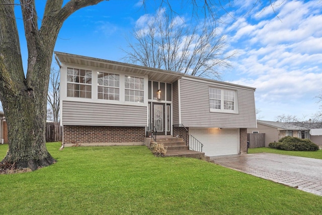 split foyer home with a garage and a front yard