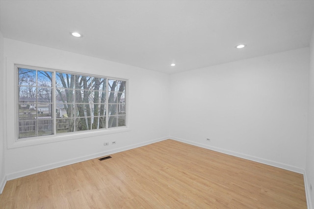 spare room with light hardwood / wood-style floors