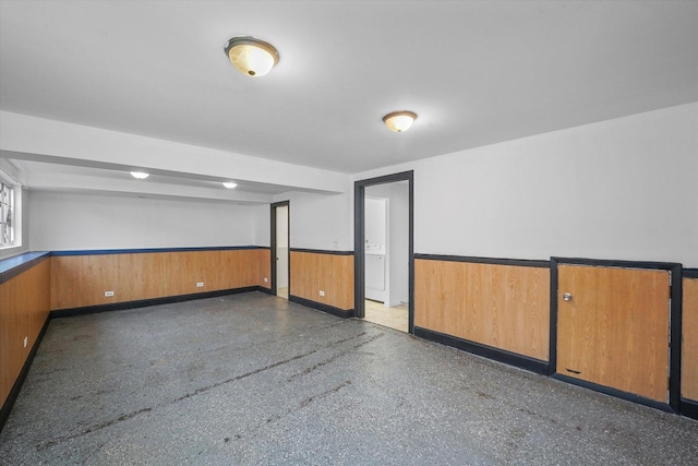 unfurnished room featuring wood walls