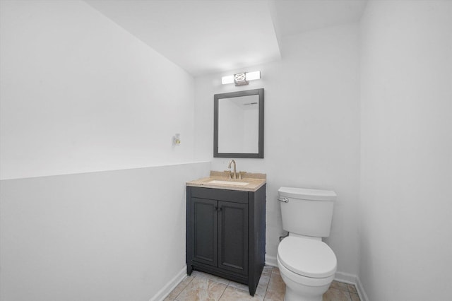 bathroom featuring vanity, tile patterned floors, and toilet