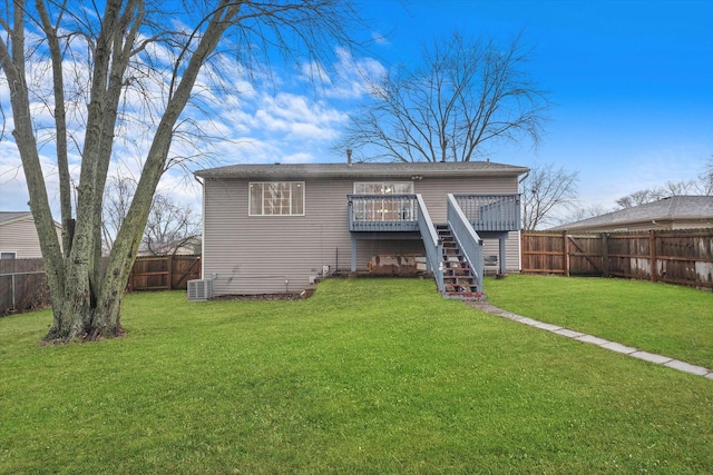 rear view of house with a wooden deck, a lawn, and central air condition unit