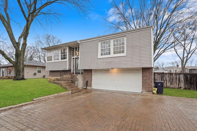 bi-level home with a garage and a front yard