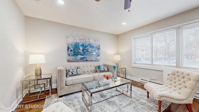 living room with ceiling fan, dark wood-type flooring, and a baseboard radiator