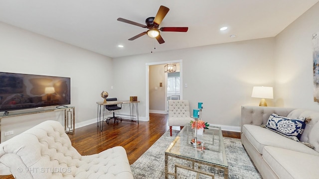 living room with ceiling fan and dark hardwood / wood-style floors