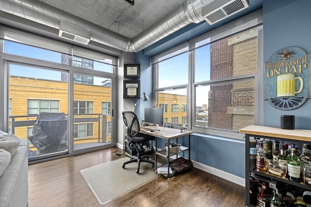 office area featuring dark wood-type flooring and a wealth of natural light