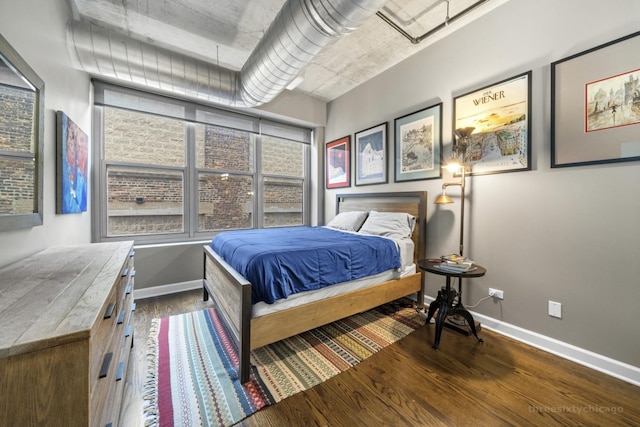 bedroom with dark hardwood / wood-style floors