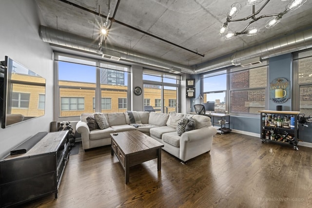 living room with dark hardwood / wood-style floors and a chandelier