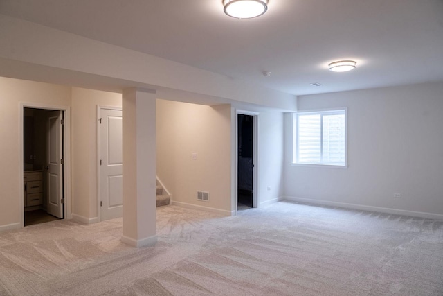 basement featuring light colored carpet