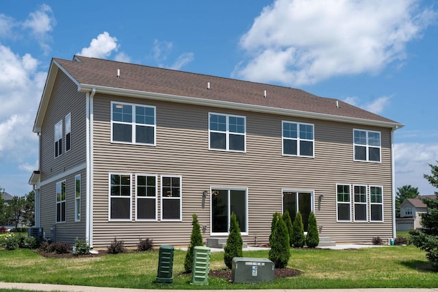 rear view of property with a yard and central AC unit