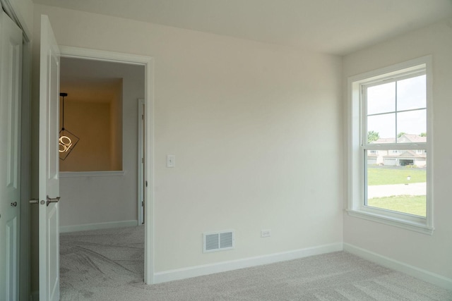 spare room with light colored carpet