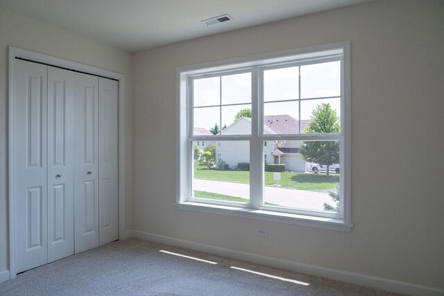 unfurnished bedroom with a closet and carpet