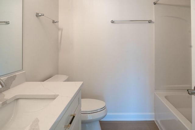 full bathroom featuring bathtub / shower combination, vanity, and toilet