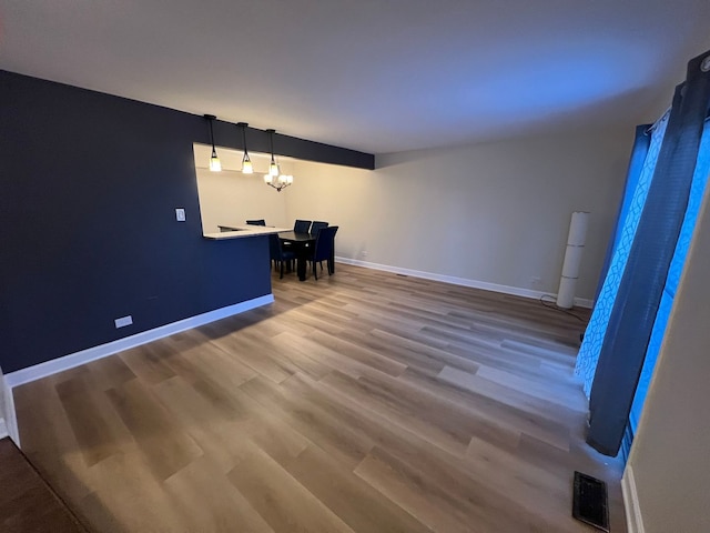 interior space featuring an inviting chandelier and wood-type flooring