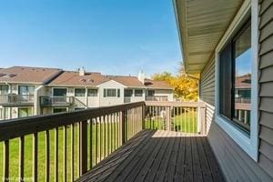 wooden terrace featuring a lawn