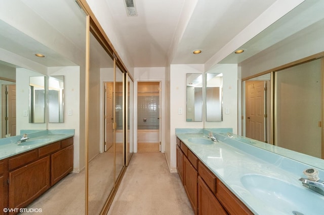 bathroom featuring vanity and independent shower and bath