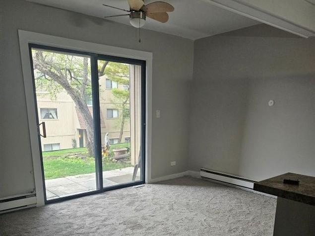 48 Oak Hill Colony Unit 2, Fox Lake, IL 60020 - spare room featuring carpet, a baseboard radiator, and ceiling fan