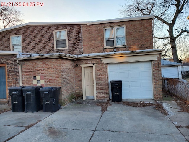 rear view of house with a garage