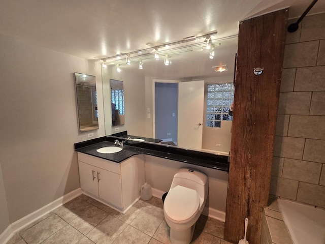 bathroom featuring tile patterned flooring, vanity, and toilet