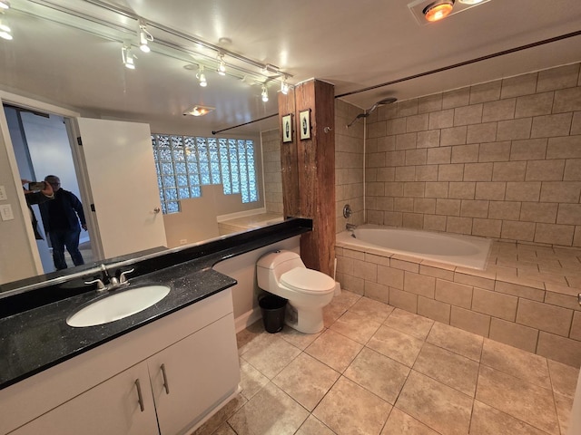 full bathroom with tiled shower / bath, toilet, tile patterned floors, and vanity