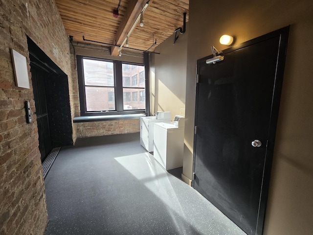 bathroom with wood ceiling, separate washer and dryer, track lighting, brick wall, and beam ceiling