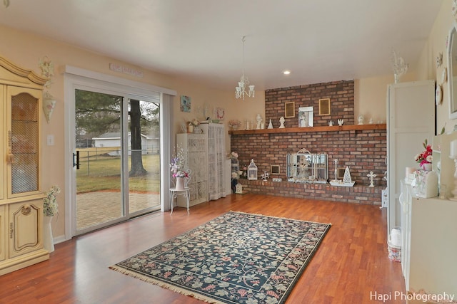 interior space featuring a fireplace, hardwood / wood-style floors, and a notable chandelier