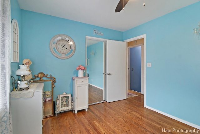 bedroom with wood-type flooring and ceiling fan