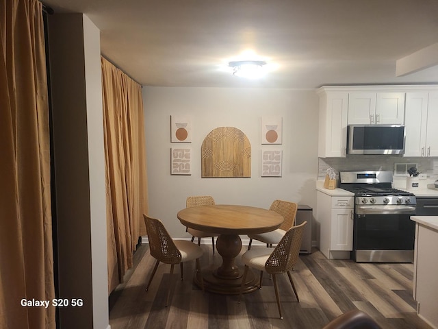 dining area with dark hardwood / wood-style floors