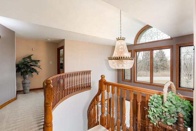 stairs with lofted ceiling, a chandelier, and carpet floors