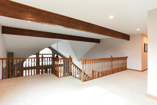 additional living space featuring ceiling fan, vaulted ceiling with beams, and carpet floors