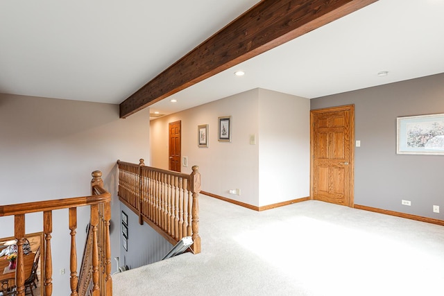 hall featuring beam ceiling and carpet floors