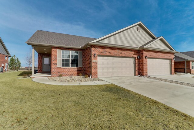 view of front of home featuring a garage and a front yard