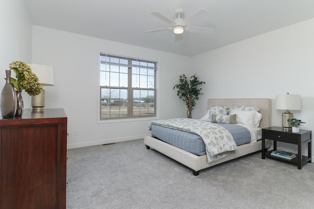 bedroom featuring ceiling fan and light carpet