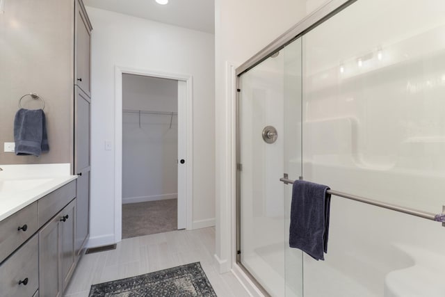 bathroom featuring vanity and a shower with shower door