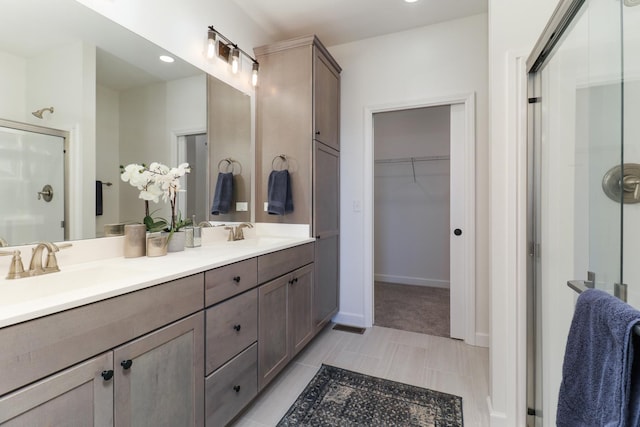 bathroom featuring vanity and a shower with shower door